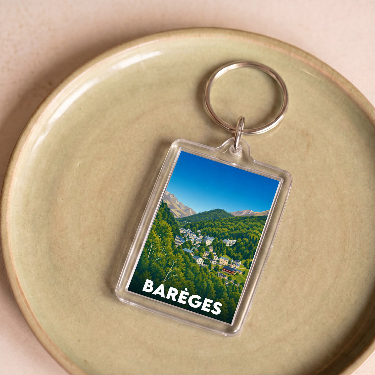 Porte-clés souvenir de la ville de Barèges avec une illustration stylisée.