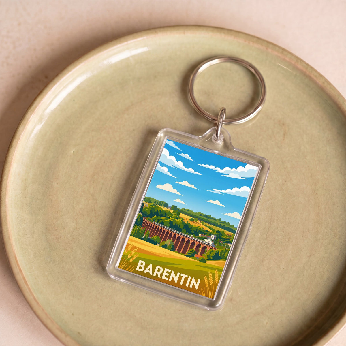 Porte-clés souvenir de la ville de Barentin avec une illustration stylisée.