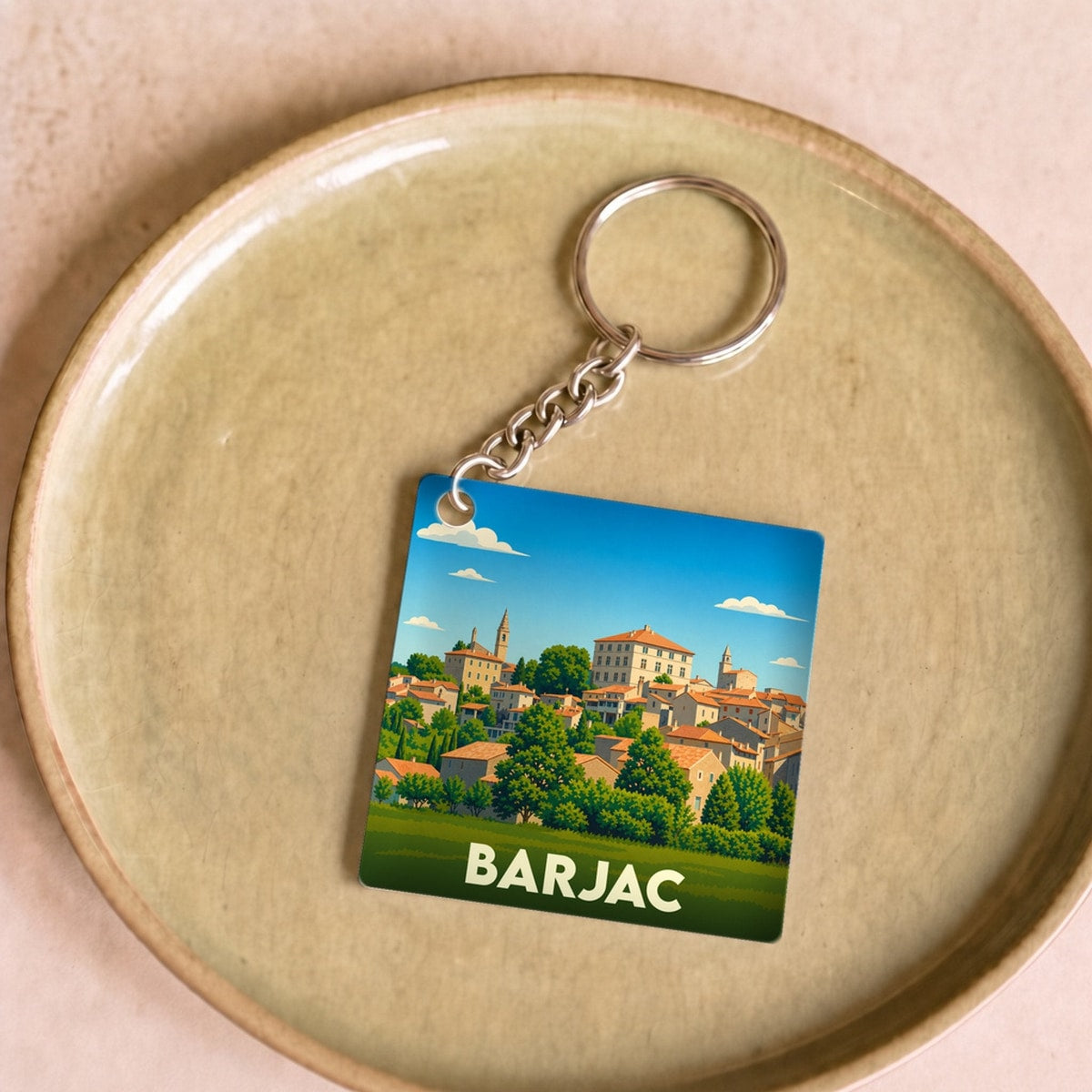 Porte-clés souvenir de la ville de Barjac avec une illustration stylisée.