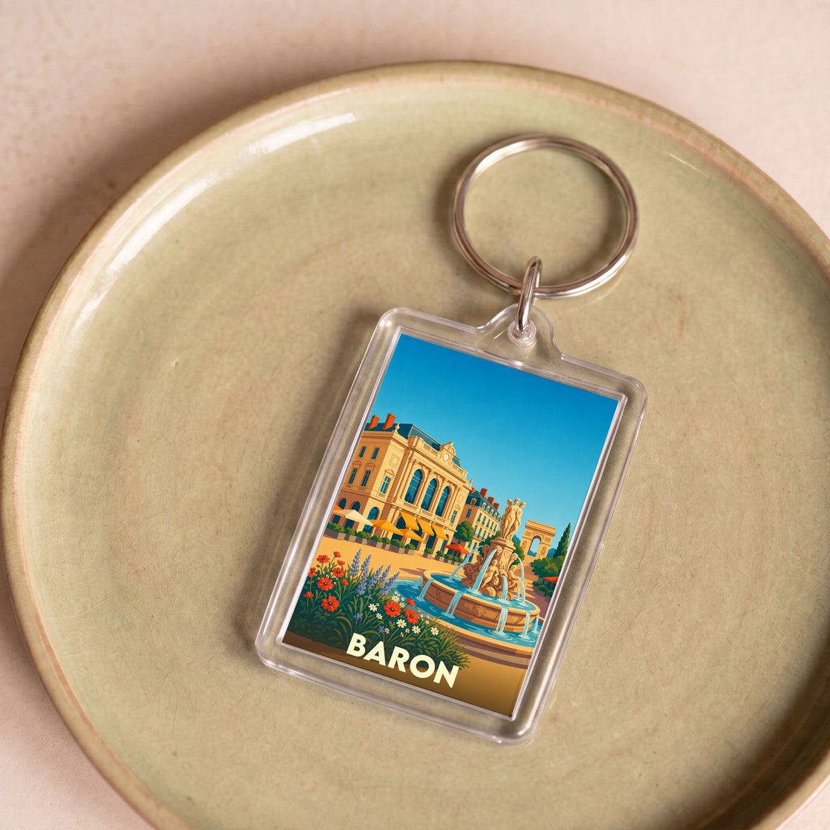 Porte-clés souvenir de la ville de Baron avec une illustration stylisée.