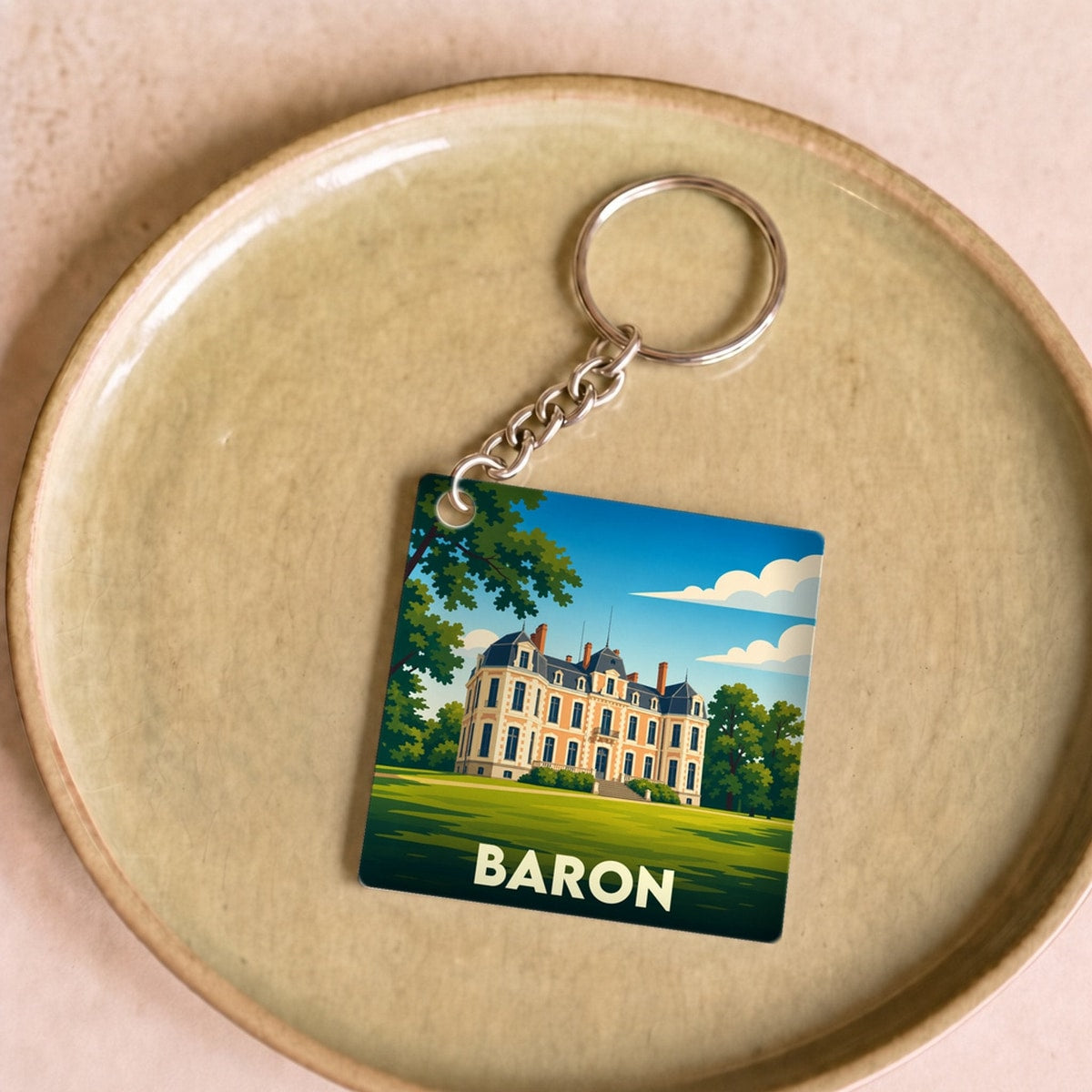 Porte-clés souvenir de la ville de Baron avec une illustration stylisée.