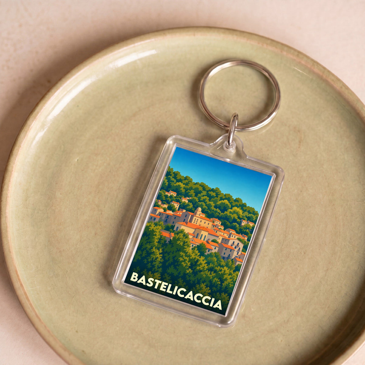 Porte-clés souvenir de la ville de Bastelicaccia avec une illustration stylisée.