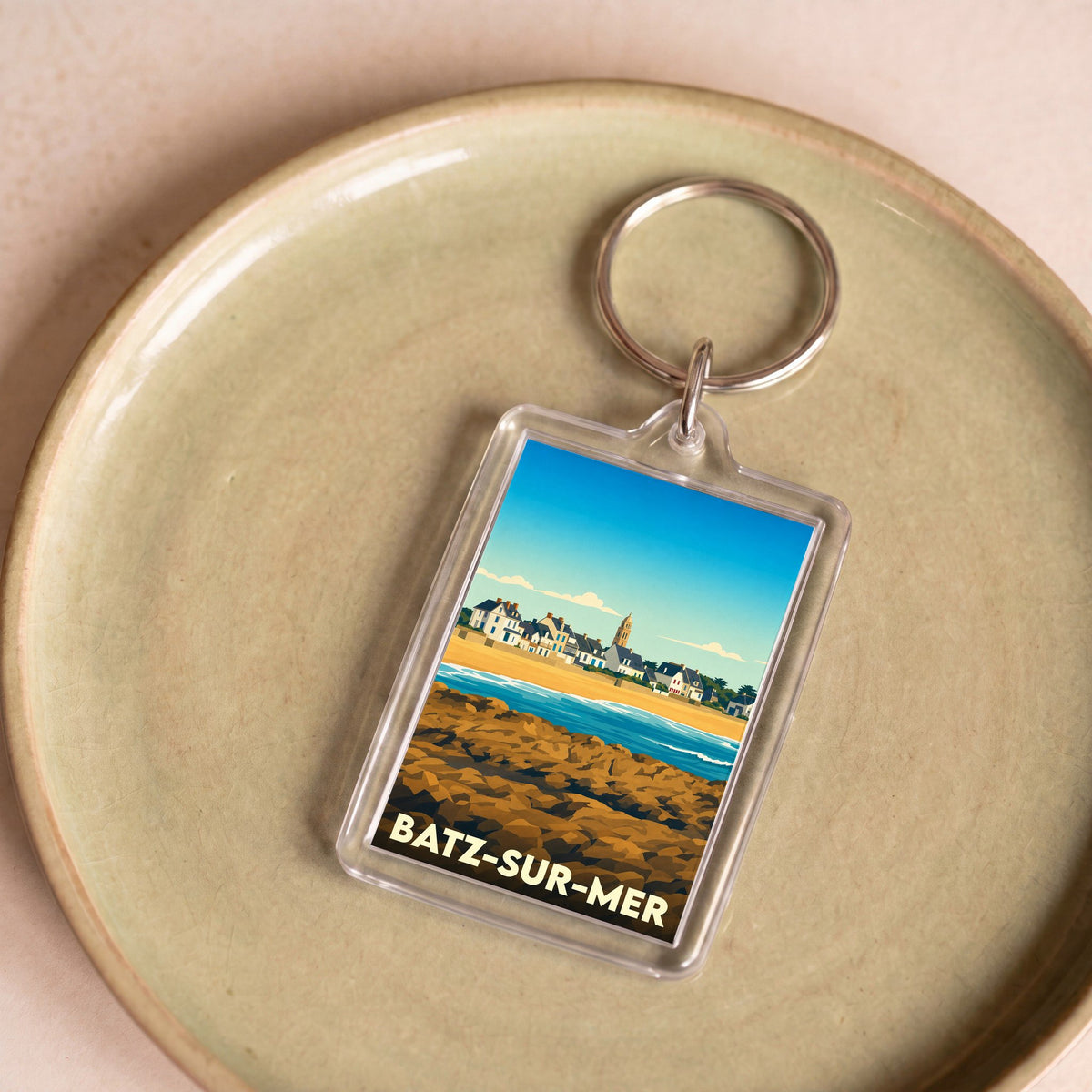 Porte-clés souvenir de la ville de Batz-sur-Mer avec une illustration stylisée de son front de mer.