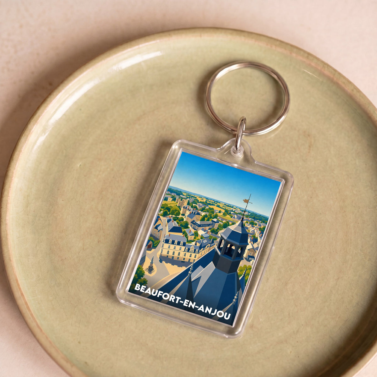 Porte-clés souvenir de la ville de Beaufort-en-Anjou avec une illustration stylisée.