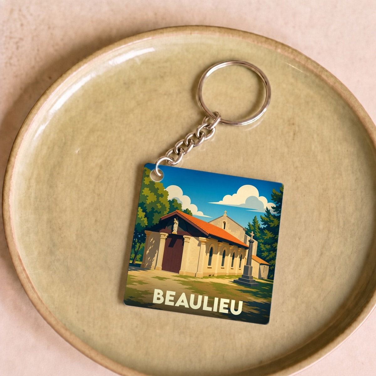 Porte-clés souvenir de la ville de Beaulieu avec une illustration stylisée.