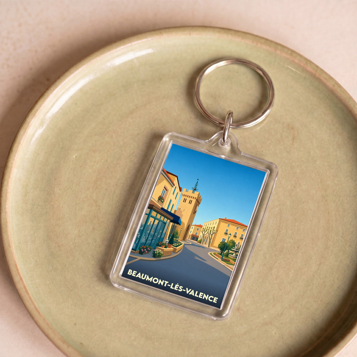 Porte-clés souvenir de la ville de Beaumont-lès-Valence avec une illustration stylisée.