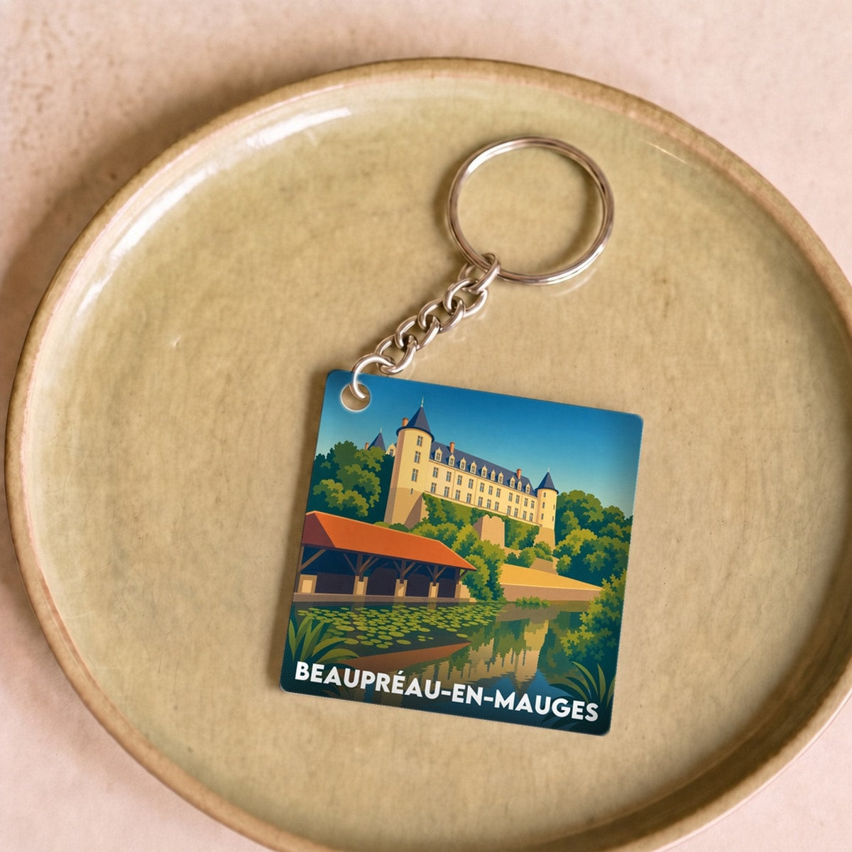 Porte-clés souvenir de la ville de Beaupréau-en-Mauges avec une illustration stylisée.