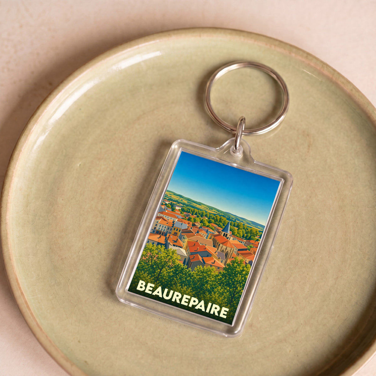 Porte-clés souvenir de la ville de Beaurepaire avec une illustration stylisée.