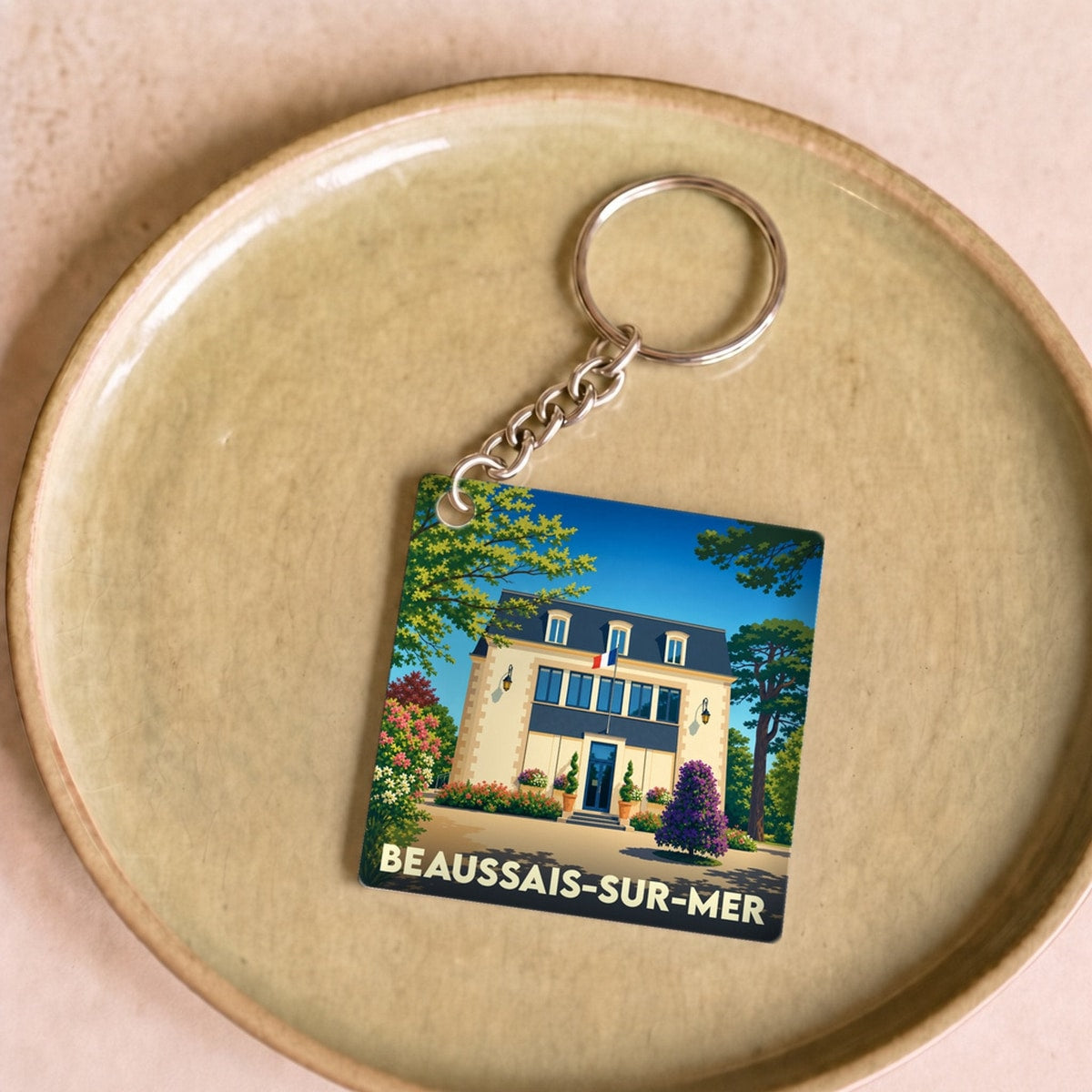 Porte-clés souvenir de la ville de Beaussais-sur-Mer avec une illustration stylisée.