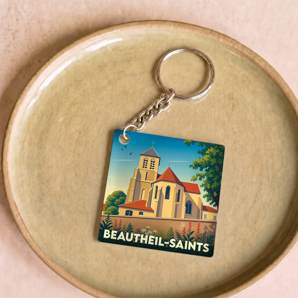 Porte-clés souvenir de la ville de Beautheil-Saints avec une illustration stylisée de son église.