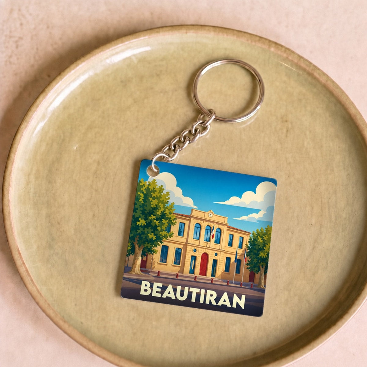 Porte-clés souvenir de la ville de Beautiran avec une illustration stylisée.