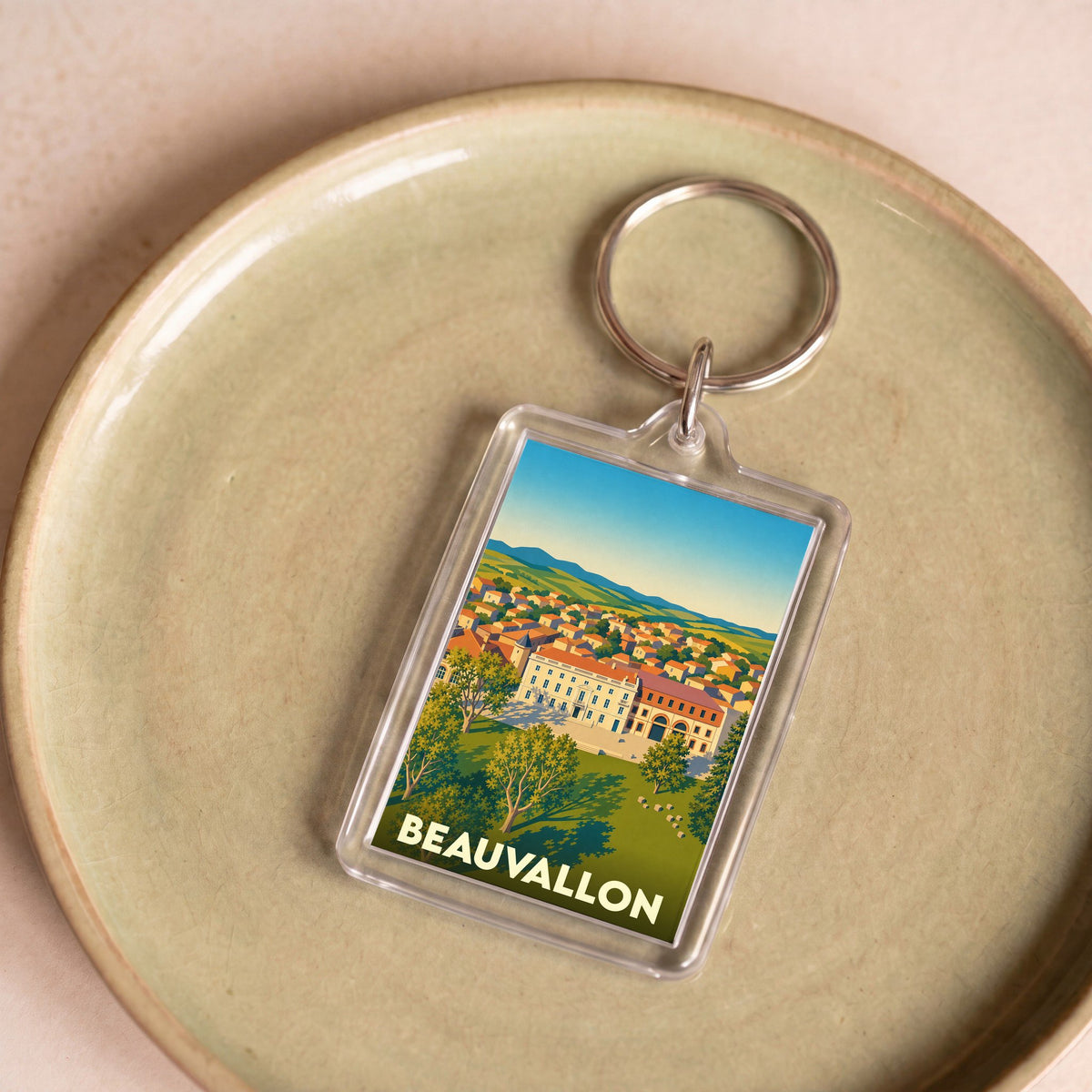 Porte-clés souvenir de la ville de Beauvallon avec une illustration stylisée.