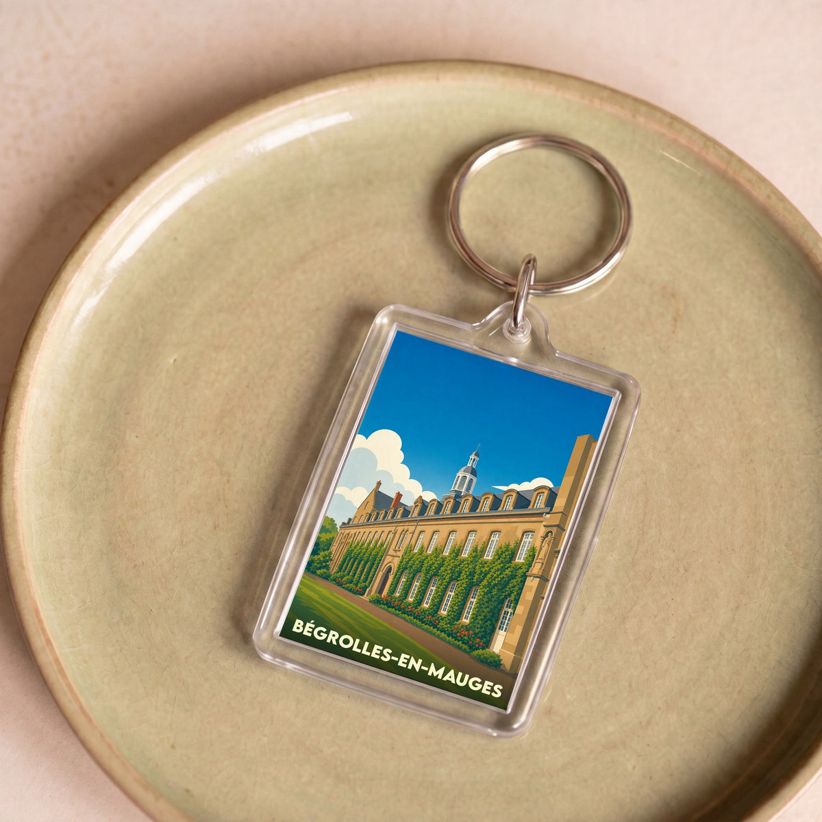 Porte-clés souvenir de la ville de Bégrolles-en-Mauges avec une illustration stylisée.