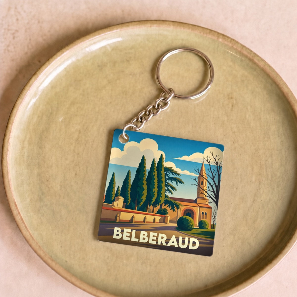 Porte-clés souvenir de la ville de Belberaud avec une illustration stylisée.