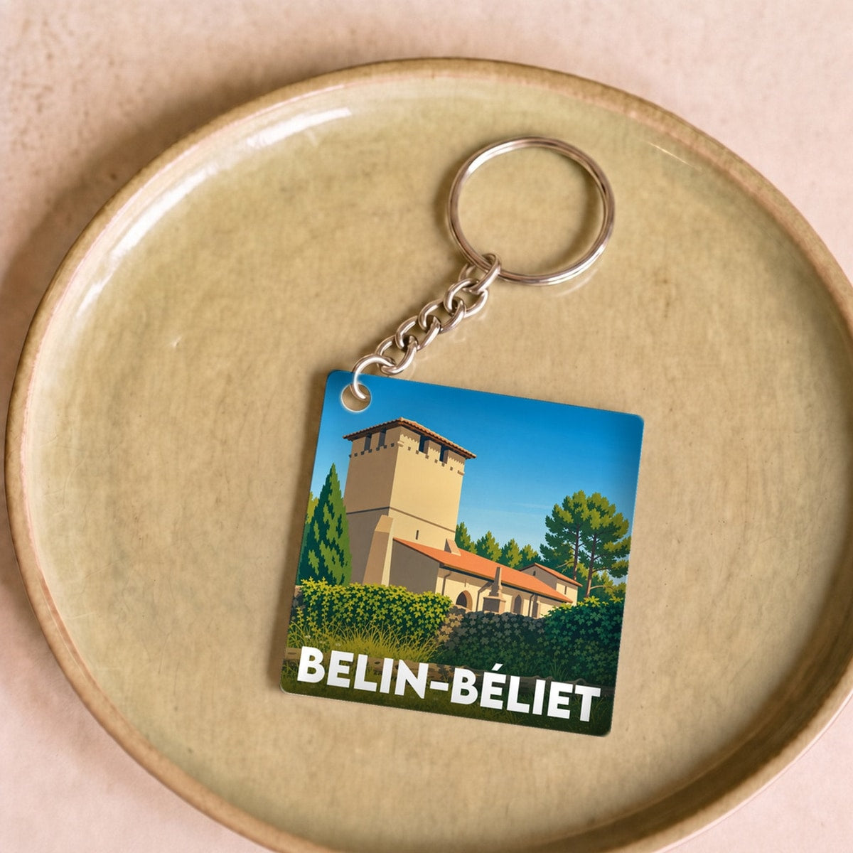Porte-clés souvenir de la ville de Belin-Béliet avec une illustration stylisée.
