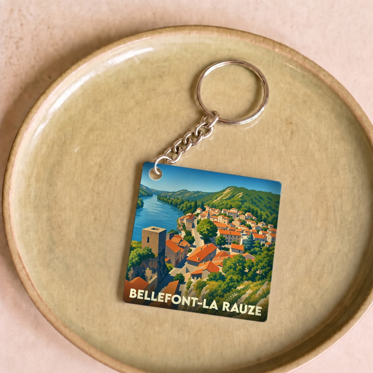 Porte-clés souvenir de la ville de Bellefont-La Rauze avec une illustration stylisée.
