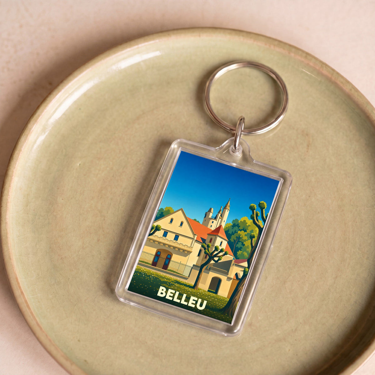 Porte-clés souvenir de la ville de Belleu avec une illustration stylisée.