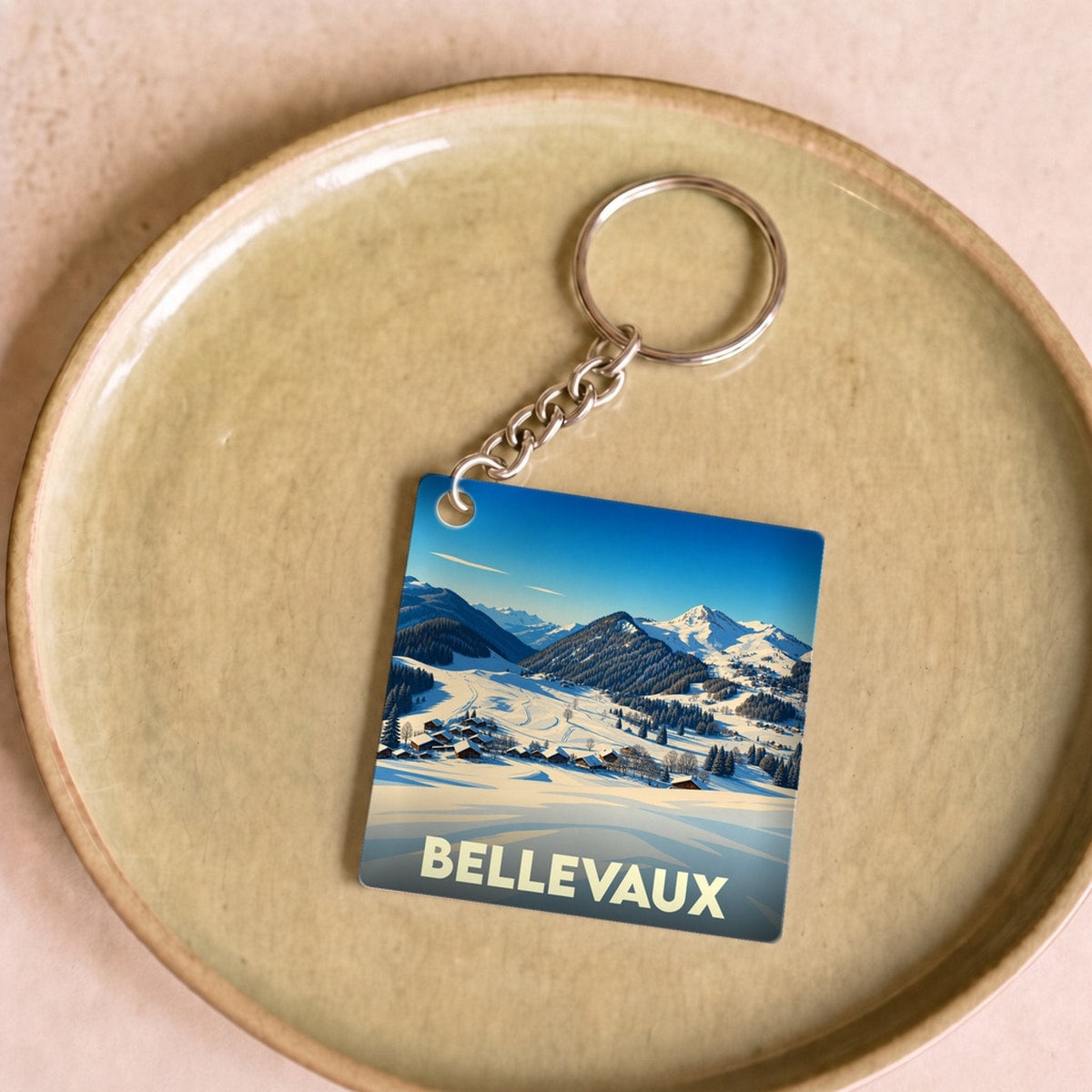 Porte-clés souvenir de la ville de Bellevaux avec une illustration hivernale stylisée.