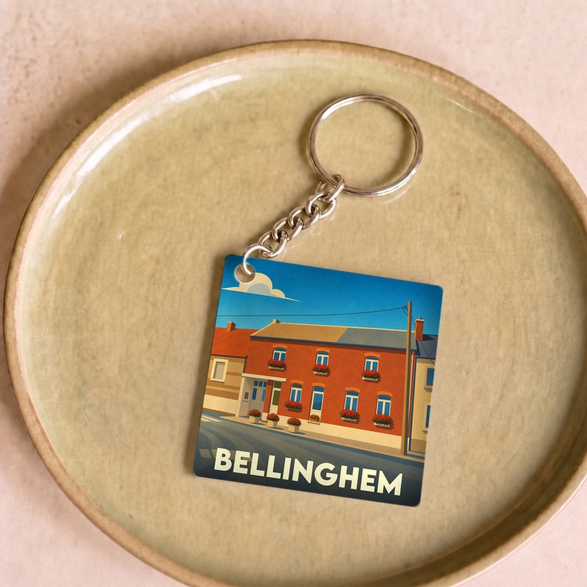 Porte-clés souvenir de la ville de Bellinghem avec une illustration stylisée.