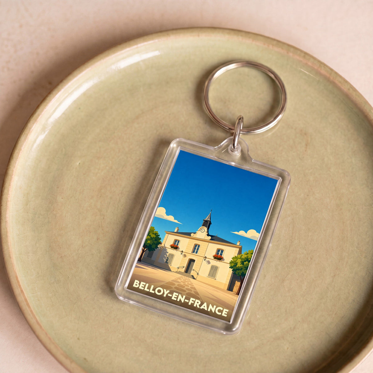 Porte-clés souvenir de la ville de Belloy-en-France avec une illustration stylisée de sa mairie.