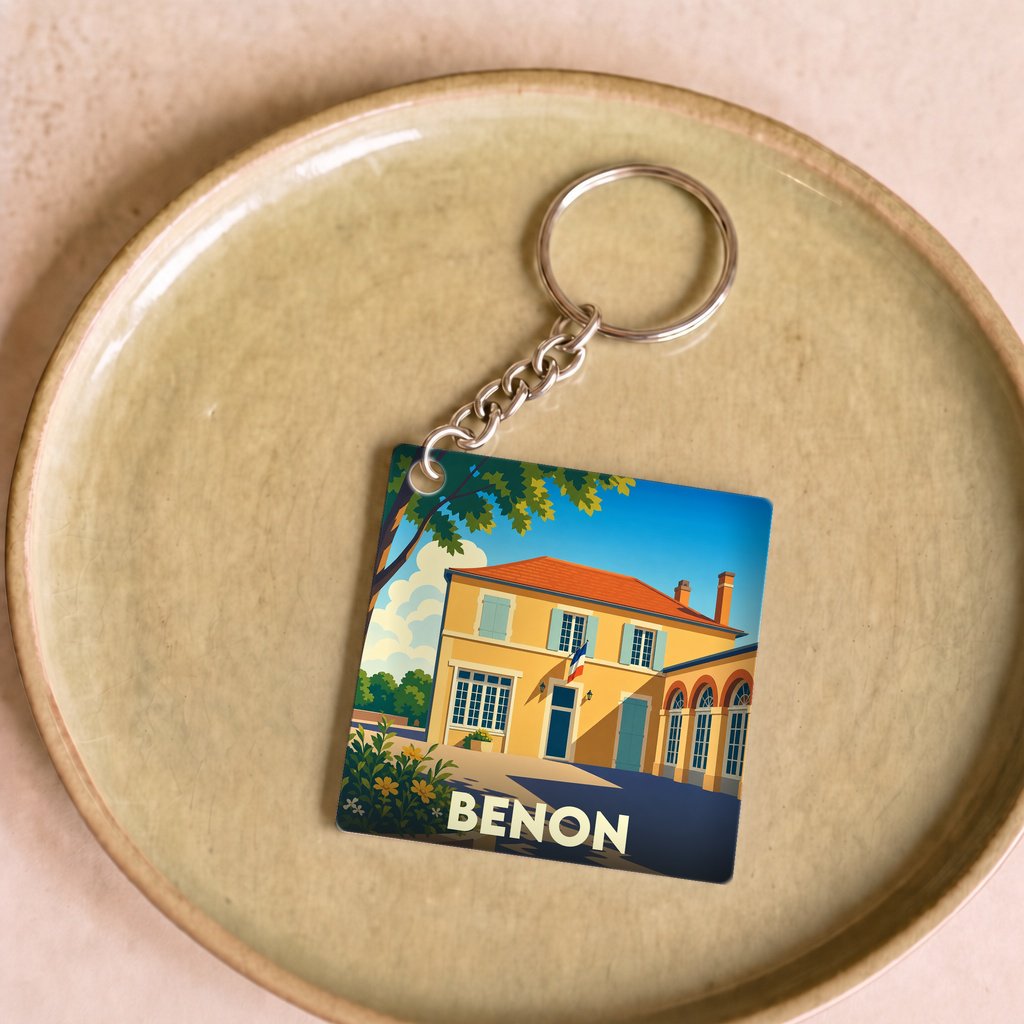 Porte-clés souvenir de la ville de Benon avec une illustration stylisée d'un bâtiment typique.