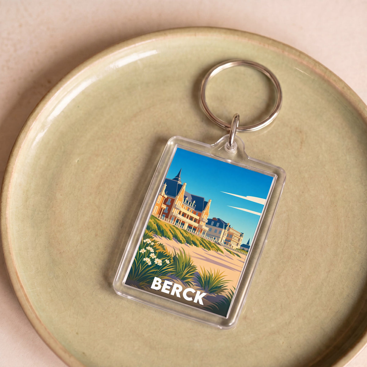 Porte-clés souvenir de la ville de Berck avec une illustration stylisée.