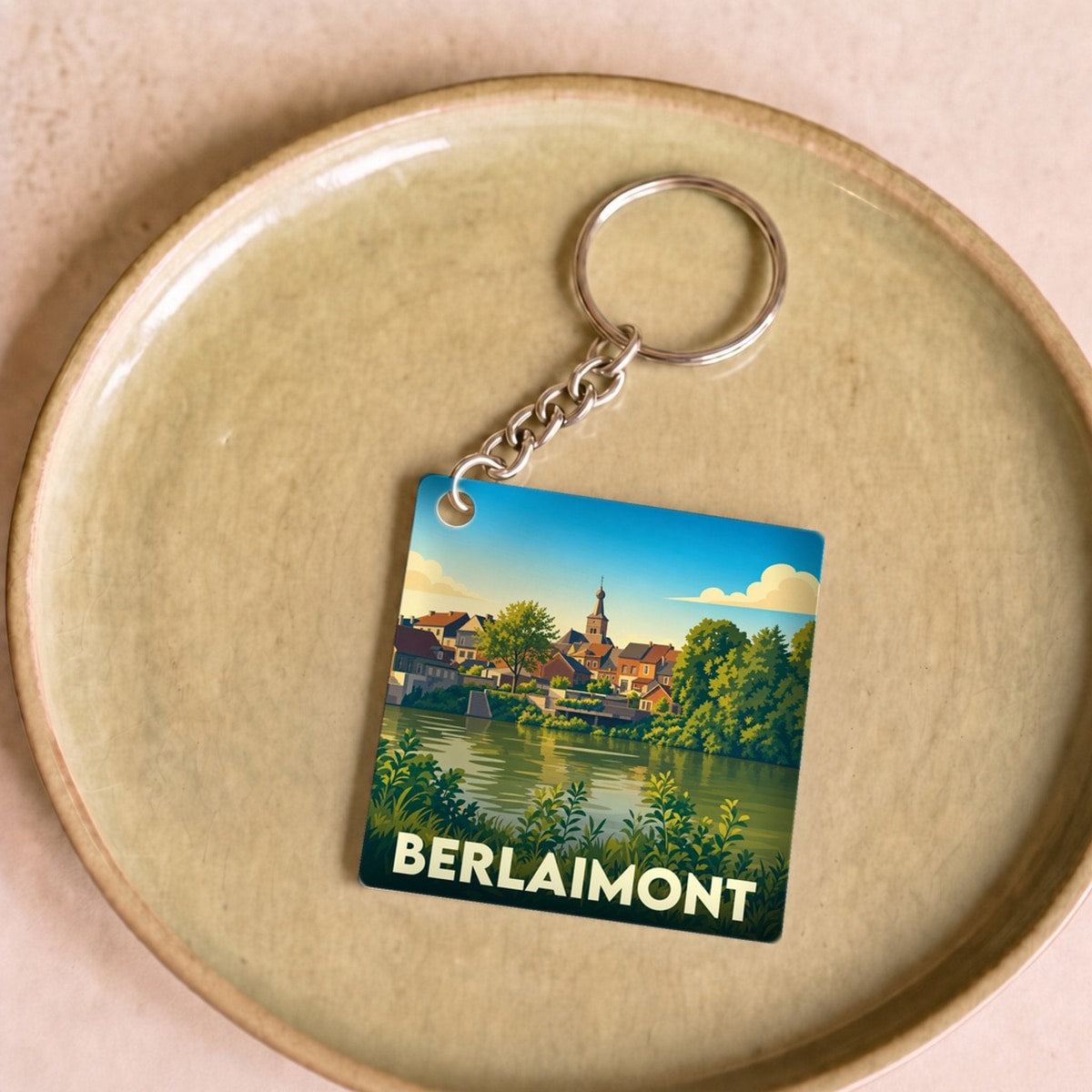 Porte-clés souvenir de la ville de Berlaimont avec une illustration stylisée.