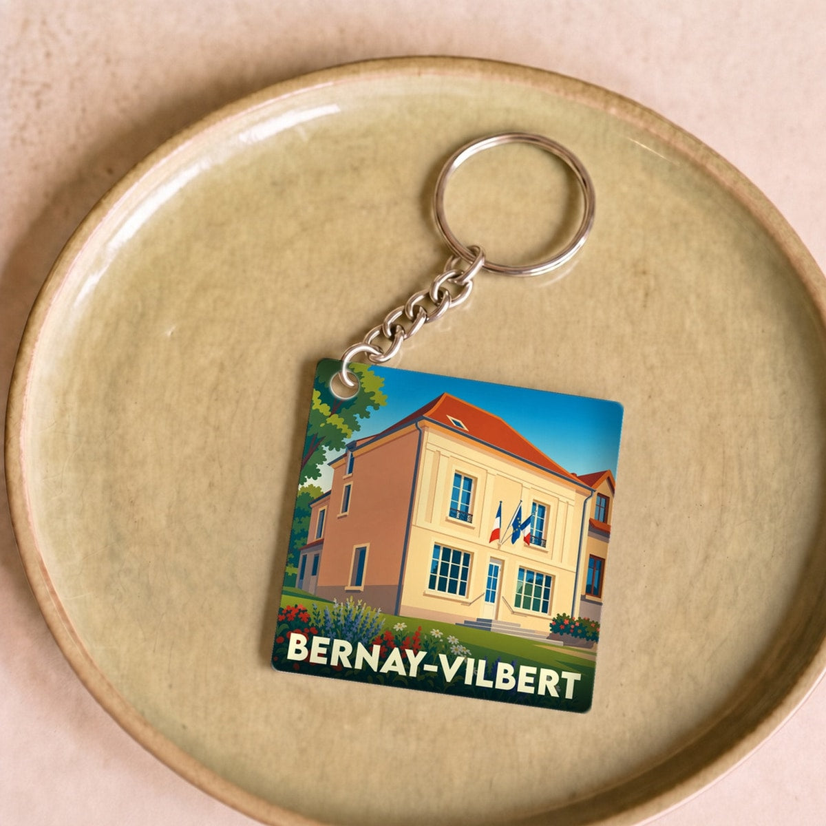 Porte-clés souvenir de la ville de Bernay-Vilbert avec une illustration stylisée.
