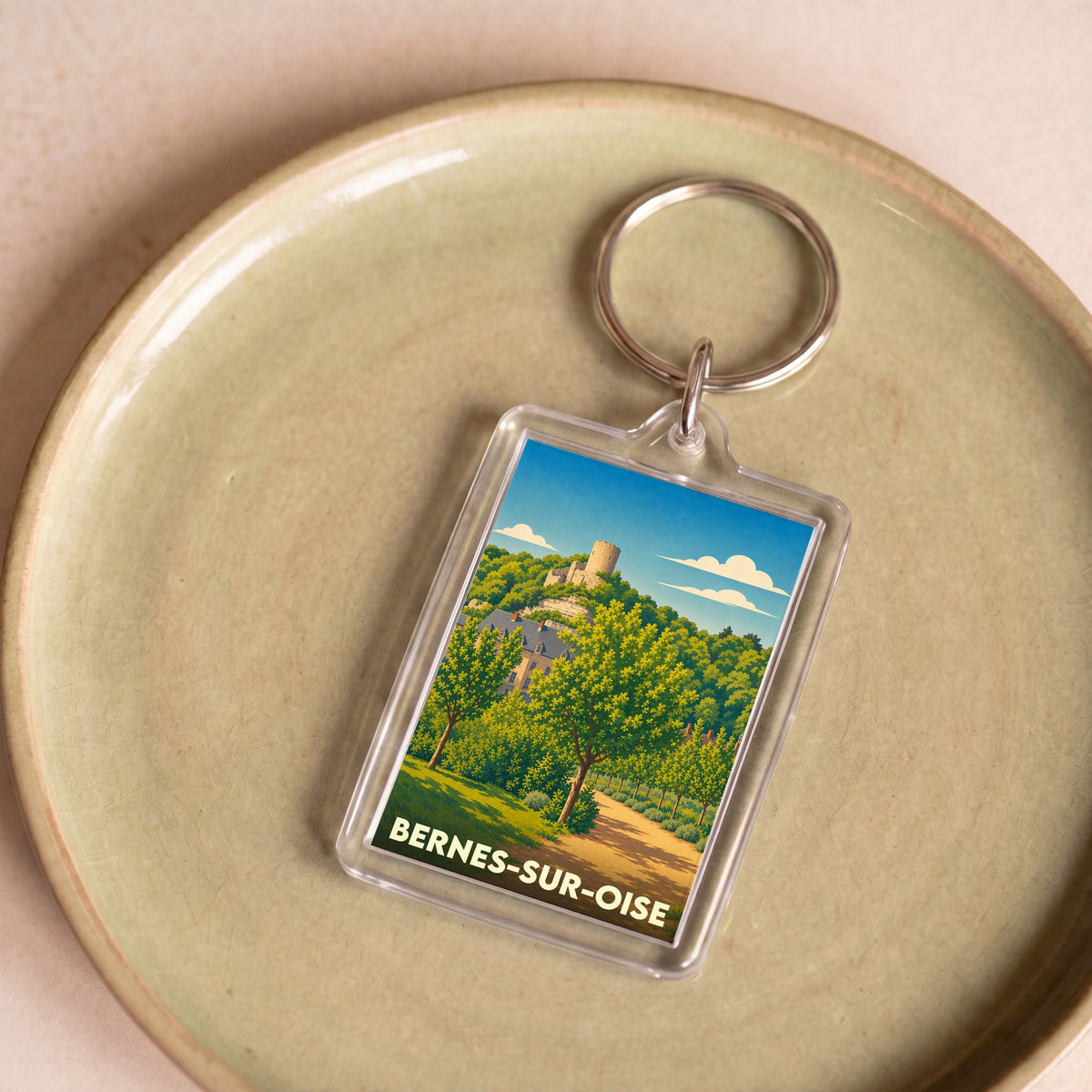 Porte-clés souvenir de la ville de Bernes-sur-Oise avec une illustration stylisée.
