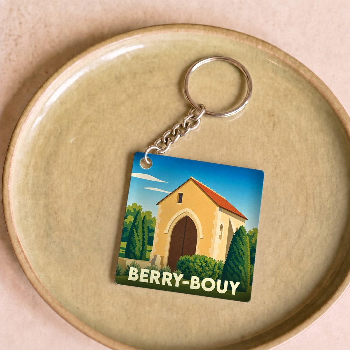 Porte-clés souvenir de la ville de Berry-Bouy avec une illustration stylisée.