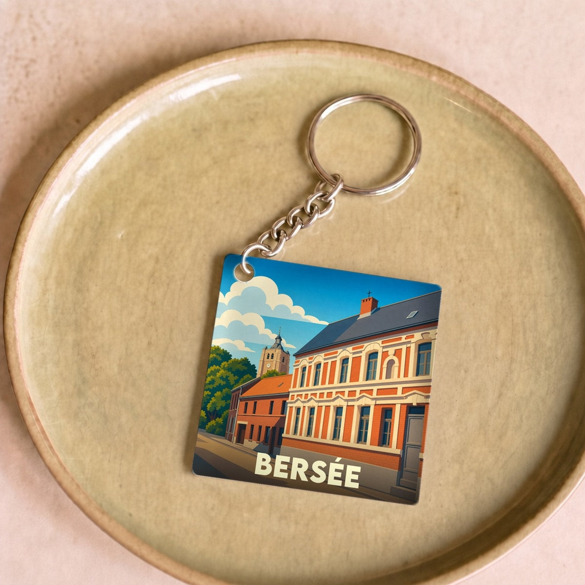 Porte-clés souvenir de la ville de Bersée avec une illustration stylisée de ses bâtiments.