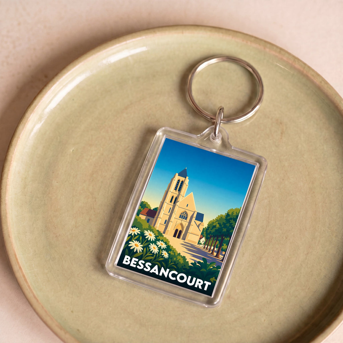 Porte-clés souvenir de la ville de Bessancourt avec une illustration stylisée de son église.