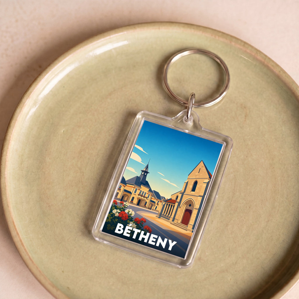 Porte-clés souvenir de la ville de Bétheny avec une illustration stylisée de son architecture.