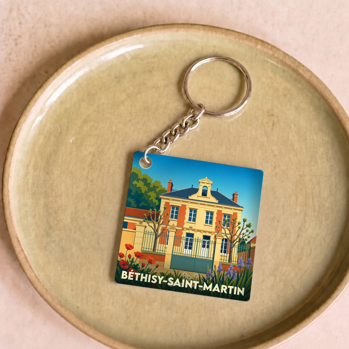 Porte-clés souvenir de la ville de Béthisy-Saint-Martin avec une illustration stylisée d'un bâtiment historique.