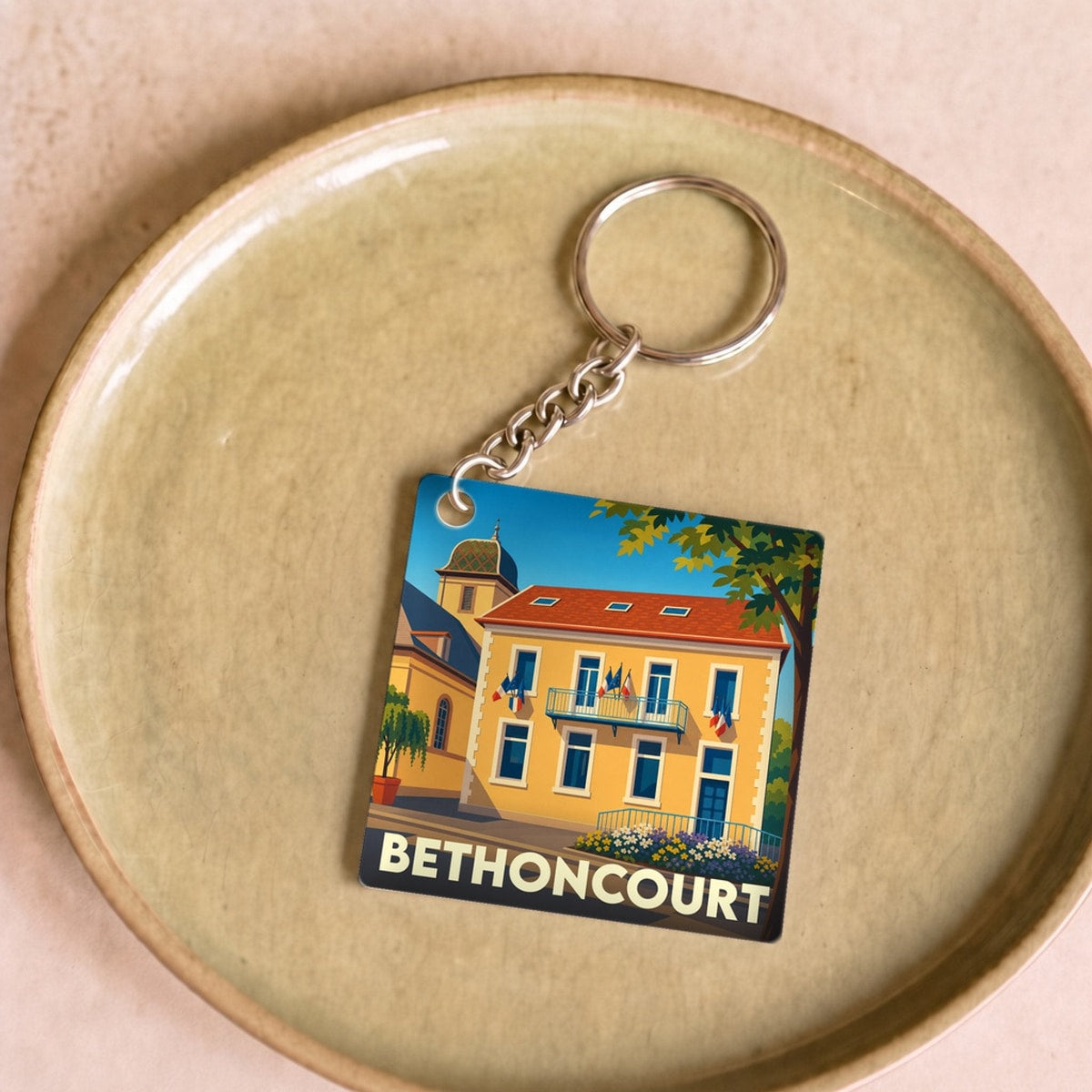 Porte-clés souvenir de la ville de Bethoncourt avec une illustration stylisée.