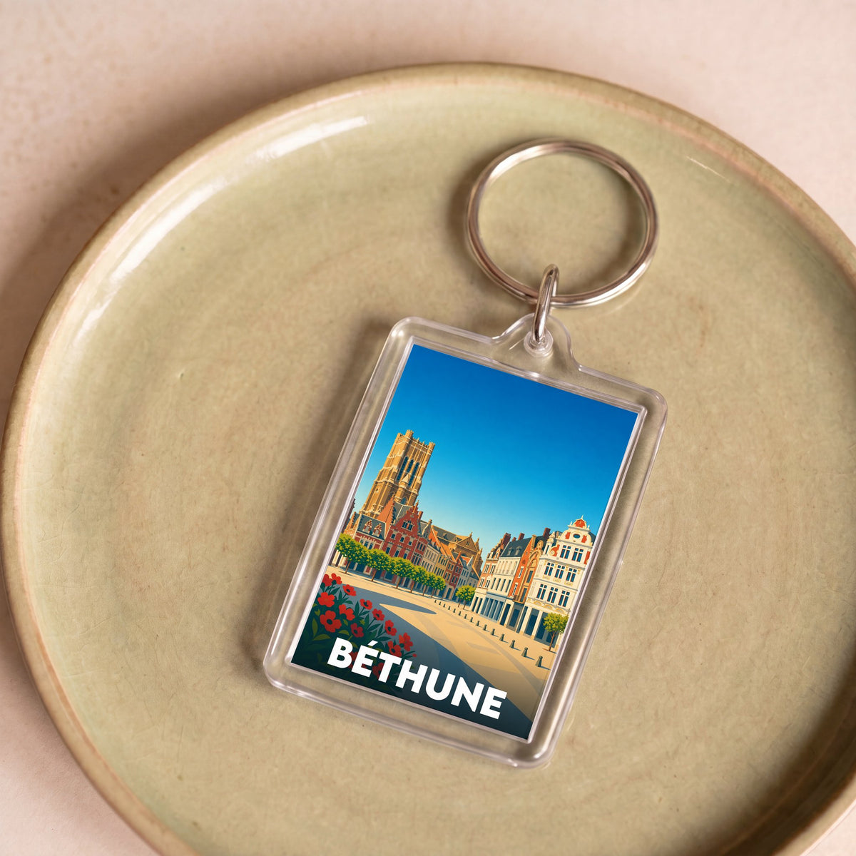 Porte-clés souvenir de la ville de Béthune avec une illustration stylisée de son architecture.