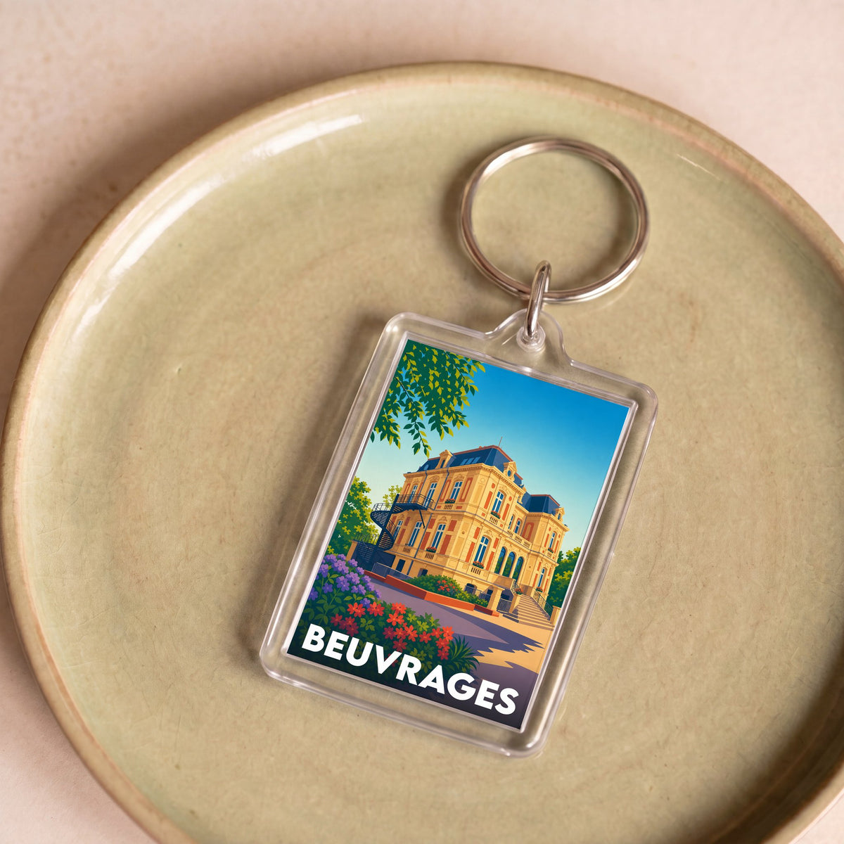 Porte-clés souvenir de la ville de Beuvrages avec une illustration stylisée d'un bâtiment historique.
