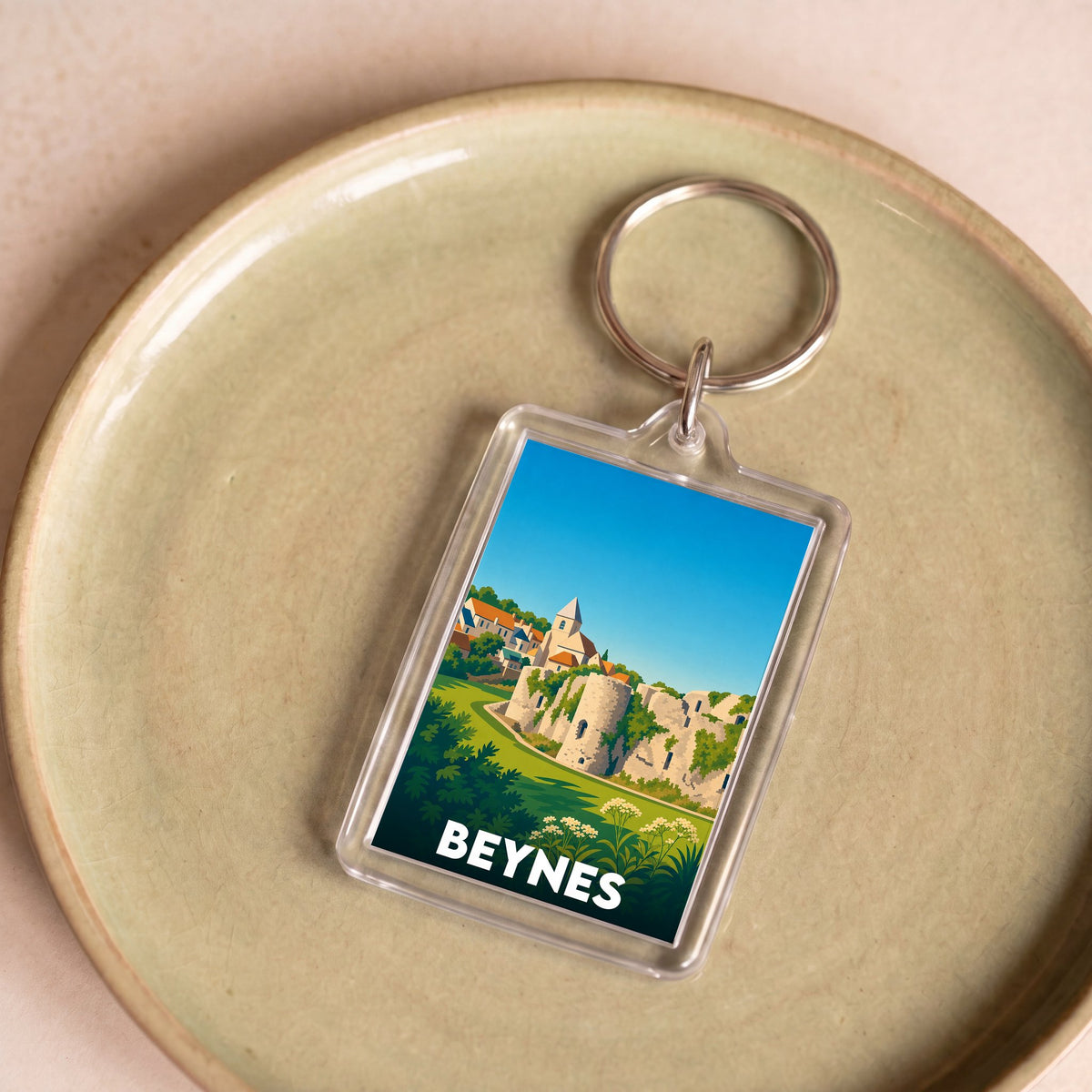 Porte-clés souvenir de la ville de Beynes avec une illustration stylisée.