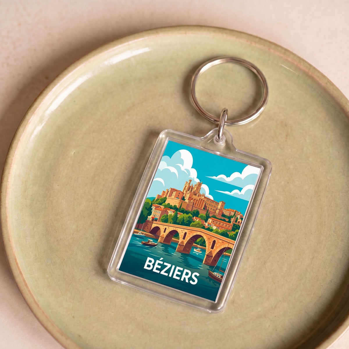 Porte-clés souvenir de la ville de Béziers avec une illustration stylisée.