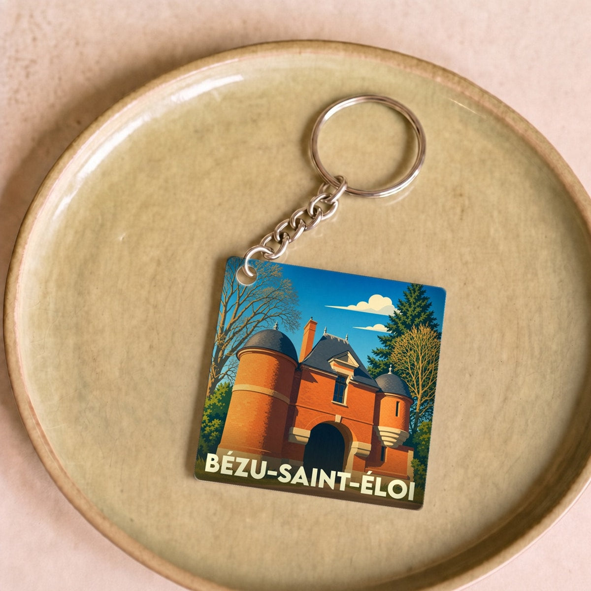 Porte-clés souvenir de la ville de Bézu-Saint-Éloi avec une illustration stylisée.