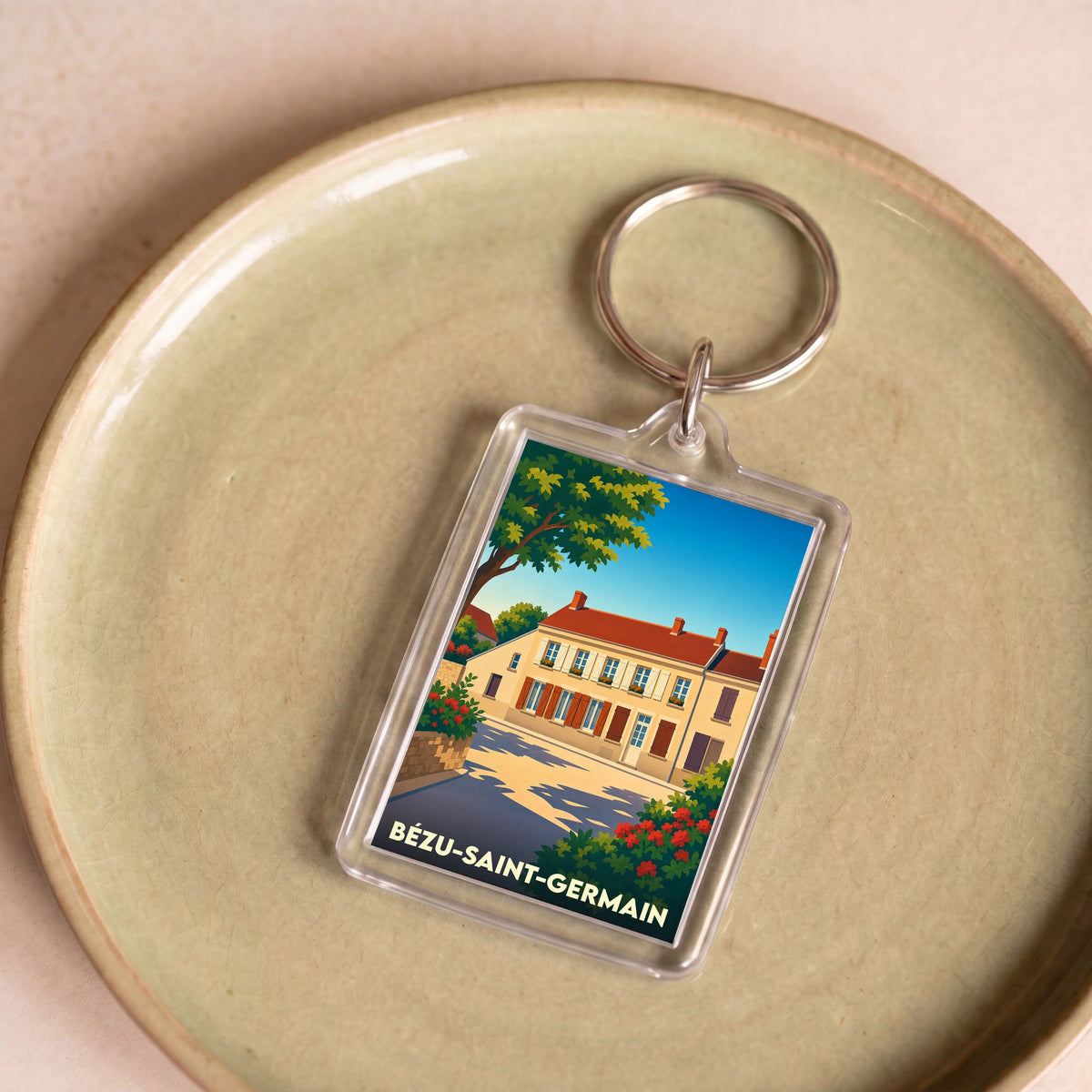 Porte-clés souvenir de la ville de Bézu-Saint-Germain avec une illustration stylisée.