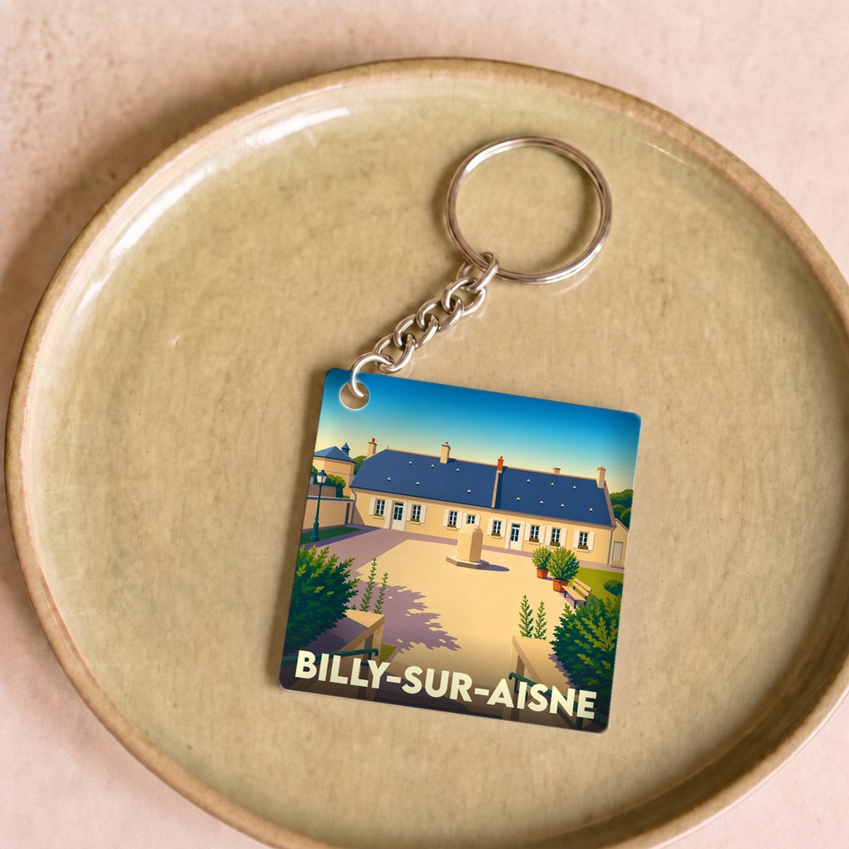 Porte-clés souvenir de la ville de Billy-sur-Aisne avec une illustration stylisée.