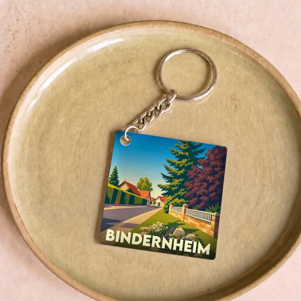 Porte-clés souvenir de la ville de Bindernheim avec une illustration stylisée de ses paysages.