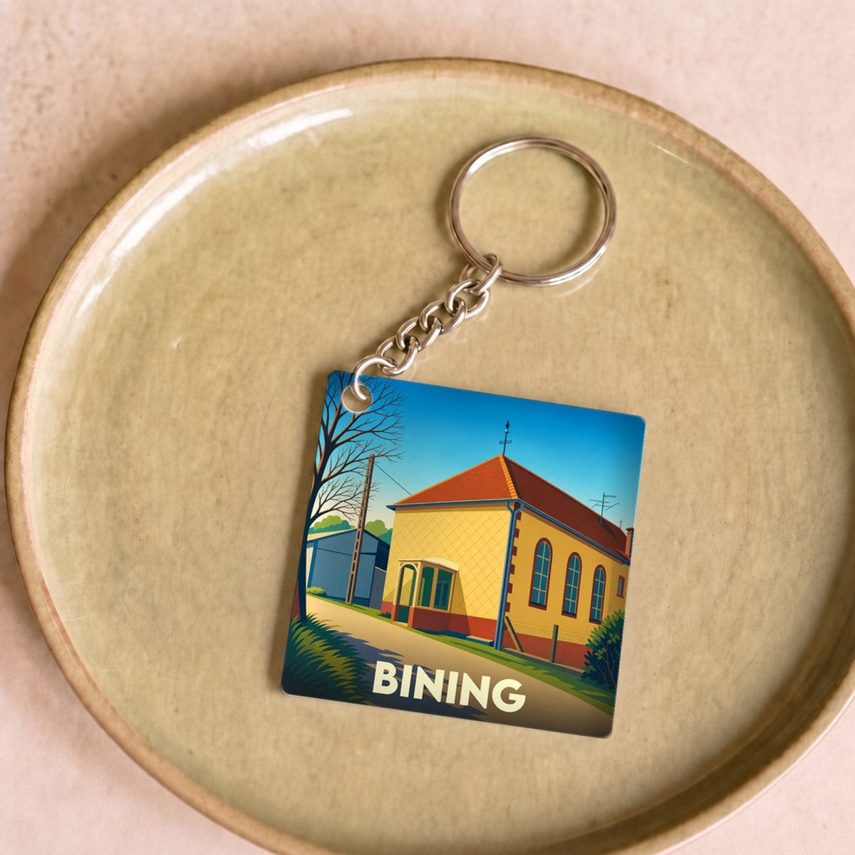 Porte-clés souvenir de la ville de Bining avec une illustration stylisée.