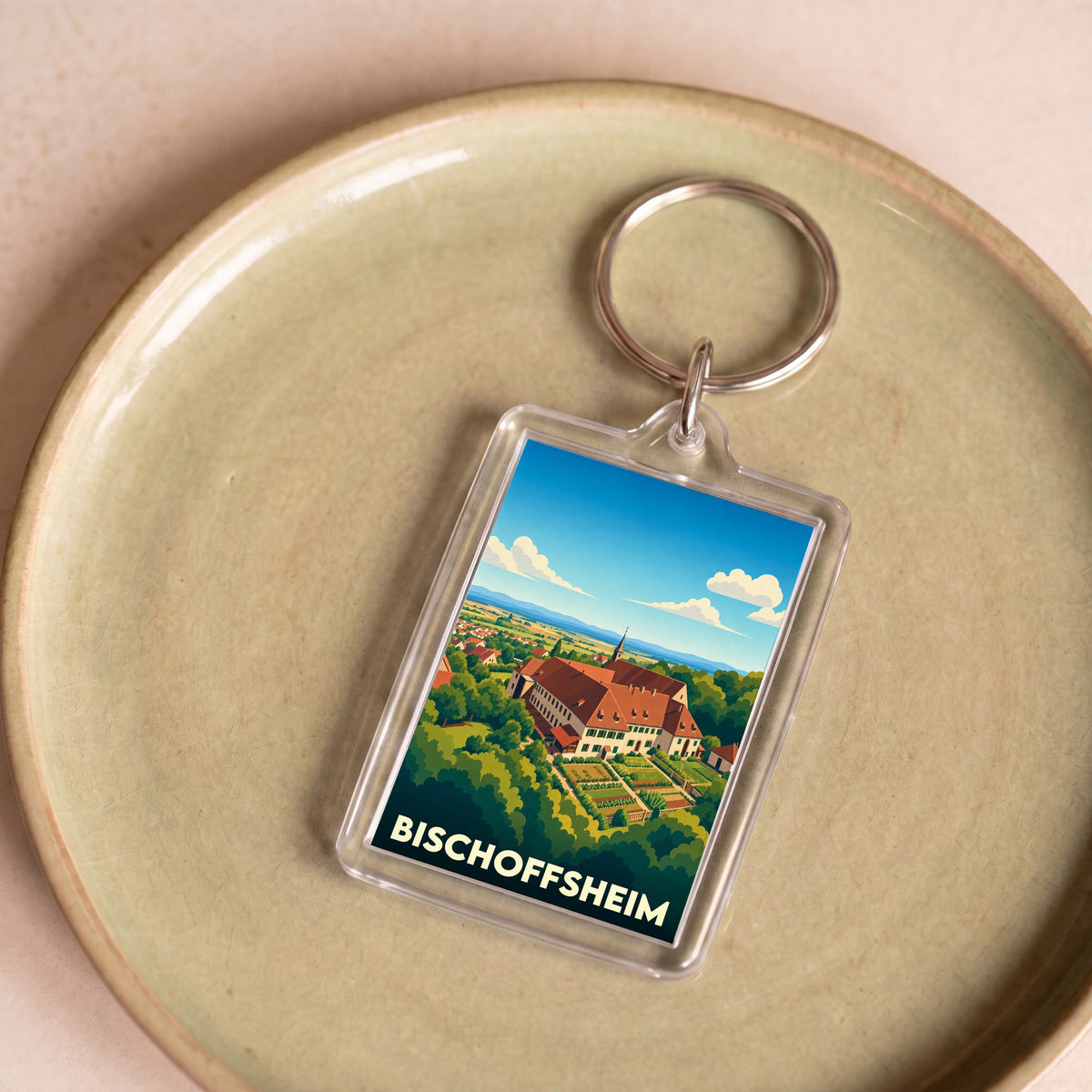 Porte-clés souvenir de la ville de Bischoffsheim avec une illustration stylisée.