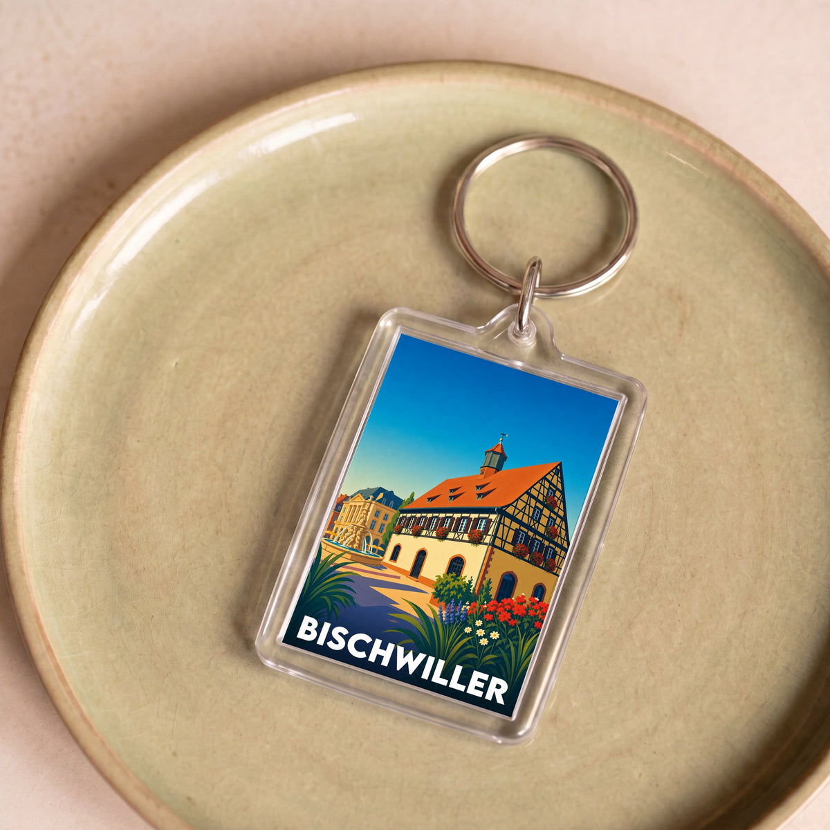 Porte-clés souvenir de la ville de Bischwiller avec une illustration stylisée.