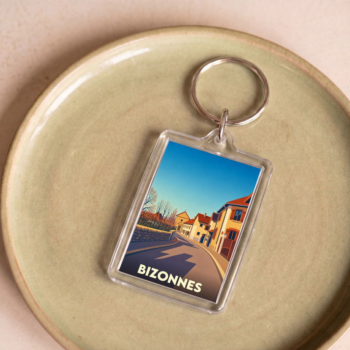 Porte-clés souvenir de la ville de Bizonnes avec une illustration stylisée.