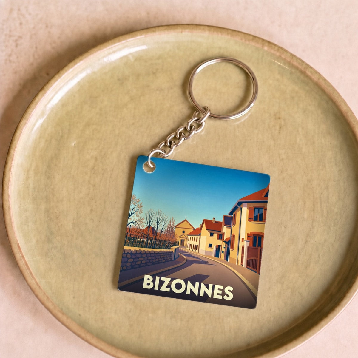Porte-clés souvenir de la ville de Bizonnes avec une illustration stylisée.