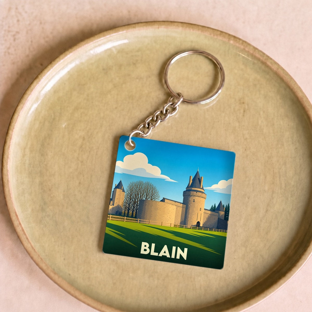 Porte-clés souvenir de la ville de Blain avec une illustration stylisée de son château.