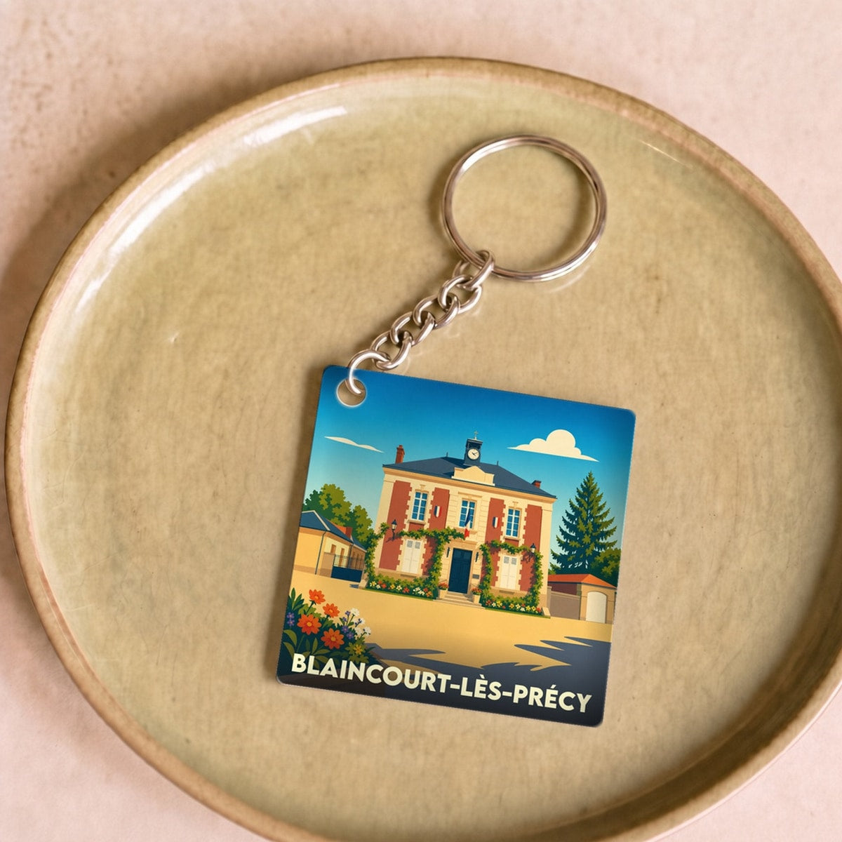 Porte-clés souvenir de la ville de Blaincourt-lès-Précy avec une illustration stylisée de sa mairie.